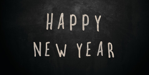 Obraz premium Happy New year written on black board typography 