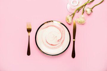 Beautiful table setting and ranunculus flowers on color background