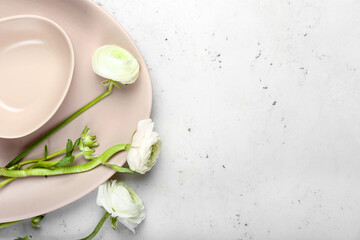 Obraz na płótnie Canvas Simple table setting and ranunculus flowers on light background