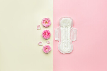 Flowers and menstrual pad on color background