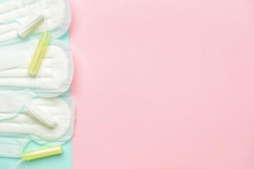 Menstrual pads and tampons on color background