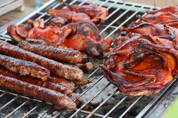 Cambodia. Khmers cook grilled beef and sausages. Siem Reap province.