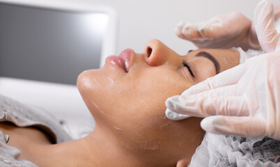 Procedure for manual cleansing of the facial skin from blackheads and acne. Beauty parlour.