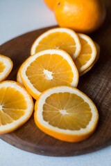 Obraz na płótnie Canvas Slices of orange juicy orange on a cutting wooden board. Sliced fruit. Vitamins.