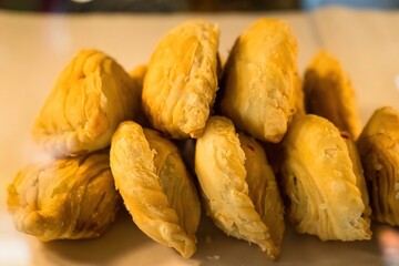 Curry puff pastry stuffed chicken and bean eat couple with tea cup