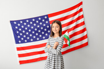 Pupil of language school near light wall with USA flag