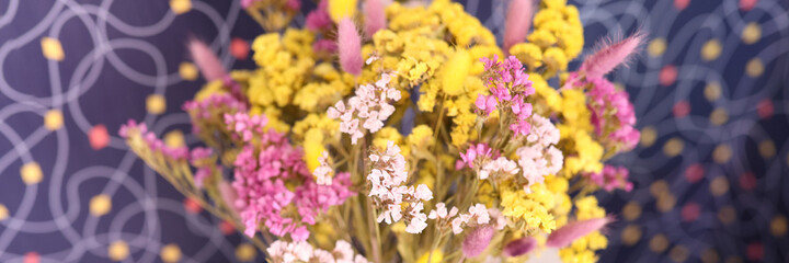 Multicolored dried statice flowers in a vase