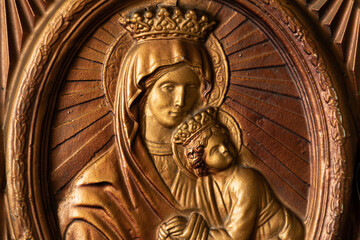 Icon of the Mother of God made of golden plastic, religion and faith in God