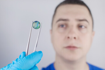 Conceptual shot of an eye crystalline lens replacement. Ophthalmic surgery. Return of sight....