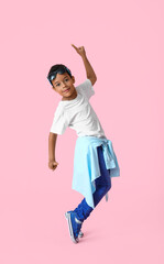 Dancing African-American boy on color background
