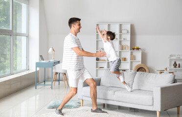 Man and his little son playing at home