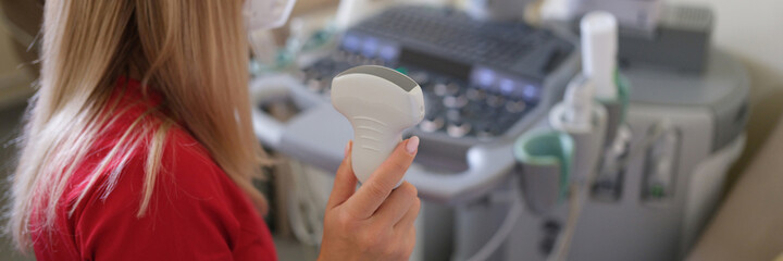 In hand of doctor holding ultrasound probe preparing for examination