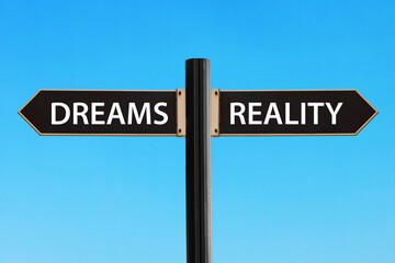 Reality versus dreams. Road sign with words reality and dreams on sky background