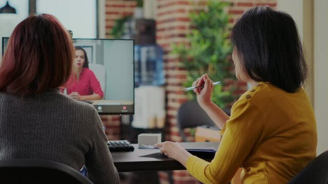 Coworkers interviewing candidate for job application on video conference, meeting on online remote video call. Team of women talking to applicant about employment at telework interview.