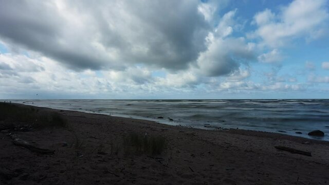 Windy sunny day with clouds by the Baltic sea on summer. Time lapse video.
