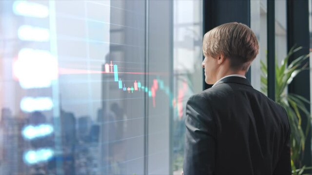 A businessman looking at Bitcoin price chart on digital exchange on mobile phone screen, cryptocurrency future price action prediction concept. Stock market, trading online, trader working
