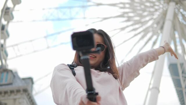 A traveller asian female talking with camera selfie with cheerful move around to show the place of vacation weekend devide happiness travel concept