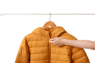 Woman zipping up down jacket on white background, closeup