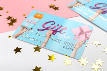 Gift card with confetti on color background, closeup