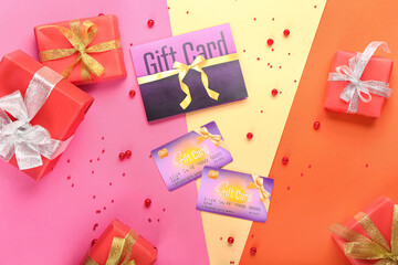 Gift card with Christmas presents and beads on color background