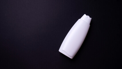 shampoo or hair conditioner bottle isolated on black background