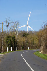 wind turbine in the countryside by the roadway
