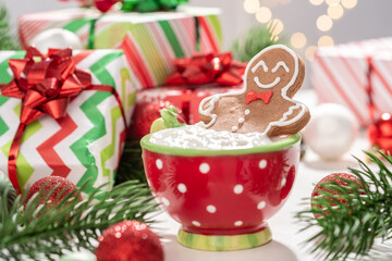 Gingerbread cookie man with a hot chocolate for Christmas. Traditional holiday symbol. Christmas holiday background.