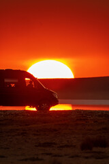 Fototapeta na wymiar Campervan at sunset in a salar lake in Turkey