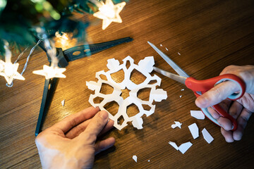 Cutting the snowflake shape out of a paper