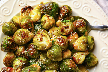 Plate with tasty roasted Brussels cabbage, closeup