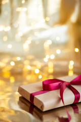 christmas wallpaper with gift box on gold background, soft focus
