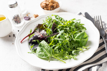 Healthy vegan green salad mix on plate. Weight loss low calories food
