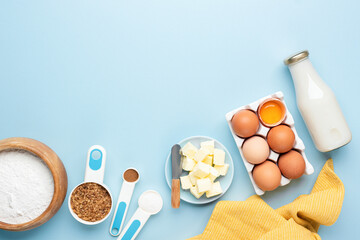 Ingredients for baking a cake on wooden table background, flat lay, copy space for text recipe or design