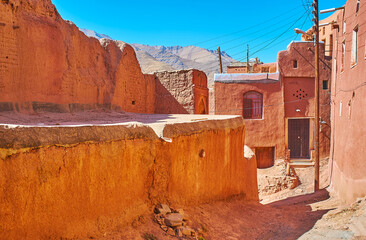 The ancient reddish walls of the living houses in mountain Abyaneh village, located in Isfahan...