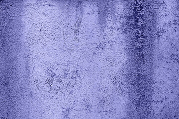 iron surface is covered with old paint texture background in very peri trendy color of the year 2022.