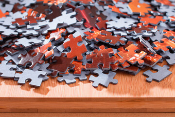 Colorful Peaces of a Mixed Jigsaw Puzzle Lie on the Wooden Table - Strategy and Solving Problem Concept