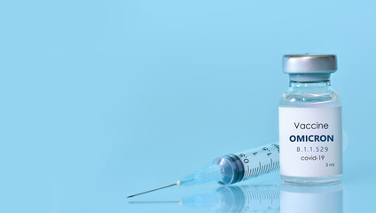 Bottle of Covid-19 vaccine to immunize from the Omicron Variant Coronavirus. The concept of medicine, healthcare and science.Copy space for text. - obrazy, fototapety, plakaty
