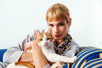 Redhead woman with cat on sofa