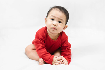 Cute infant baby boy toddler in red bodysuit.Concept holiday Christmas, happy new year, infants, childhood.