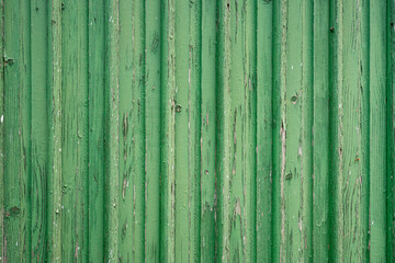 green outdated wood planks where the paint is peeling off
