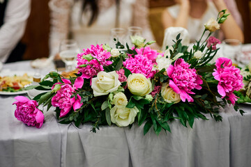 tabletop wedding flower arrangement with pink peonies