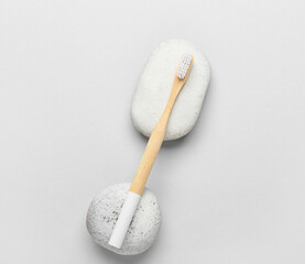 Wooden toothbrush on grey background