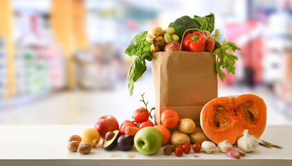 Recyclable shopping bag with fruits and vegetables with supermarket background