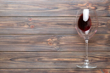 One glasses of red wine at wine tasting. Concept of red wine on colored background. Top view, flat lay design