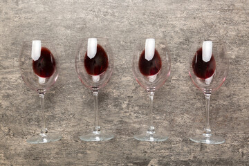 Many glasses of red wine at wine tasting. Concept of red wine on colored background. Top view, flat lay design