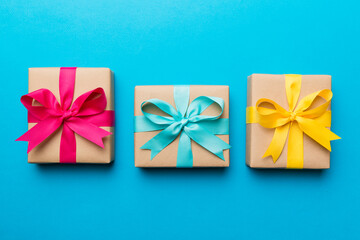 Holiday present box over colored background, top view