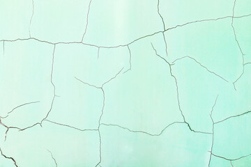 green wall with deep cracks illuminated by the sunbeam. technical structure