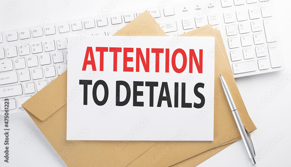 Poster text attention to details on the envelope on the keyboard