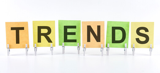 The phrase TRENDS is written on multi-colored stickers, on the white background. Business concept,...