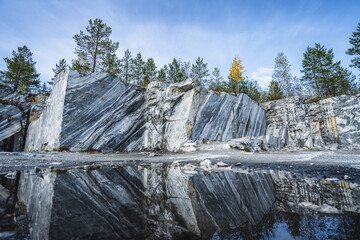 Italian quarry with smooth sections of marble in the Ruskeala Mountain Park on a sunny summer day - obrazy, fototapety, plakaty